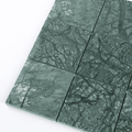 Green marble tiles with a pattern on a white background