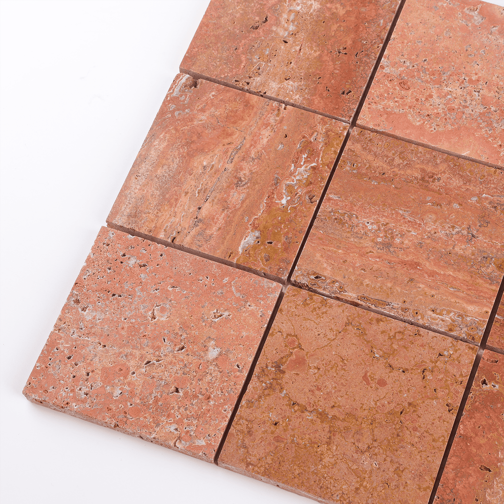Close-up of red travertine tiles on a white background