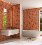 Modern bathroom with red tiled walls, white fixtures, and a large mirror.