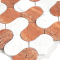 Close-up of a patterned tile with red and white colors on a white background