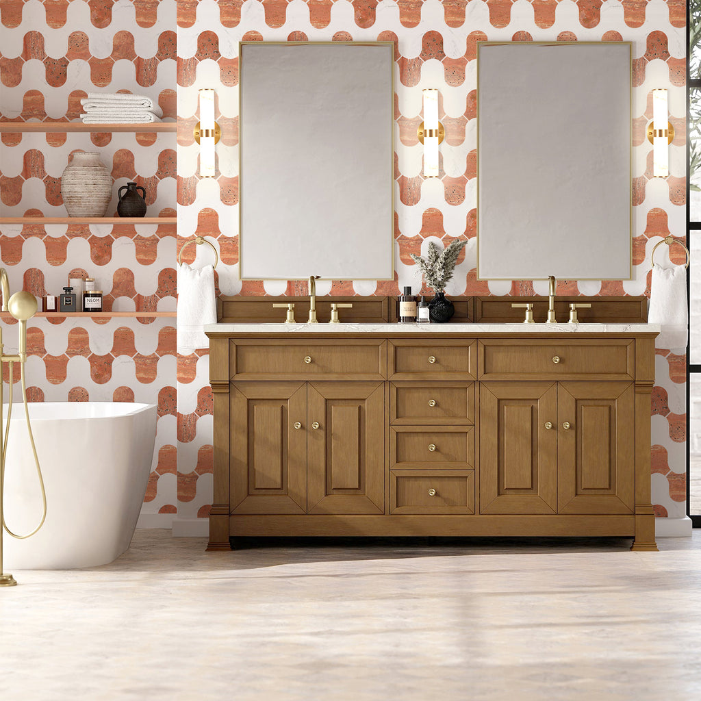 Bathroom with wooden vanity, mirrors, and patterned wallpaper