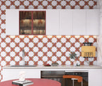 Modern kitchen with decorative wall tiles and white cabinets.