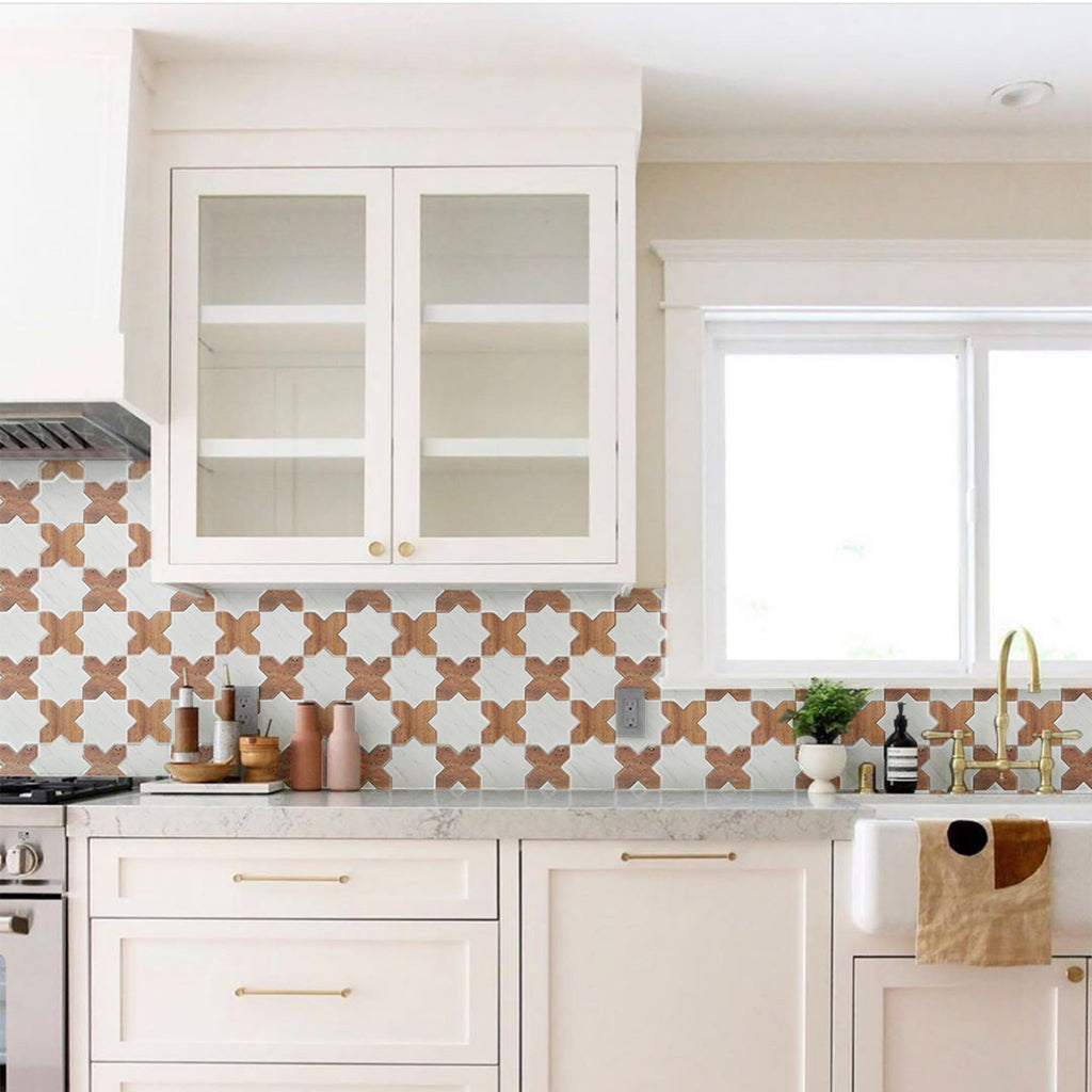 Modern kitchen with white cabinets, patterned backsplash, and marble countertop.