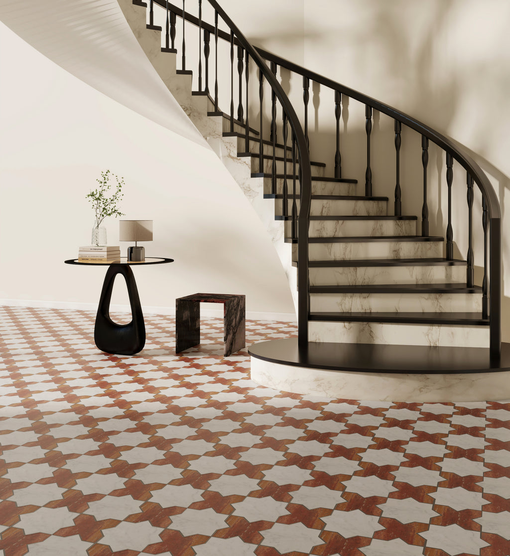 Staircase with decorative railing in a room with patterned floor tiles.