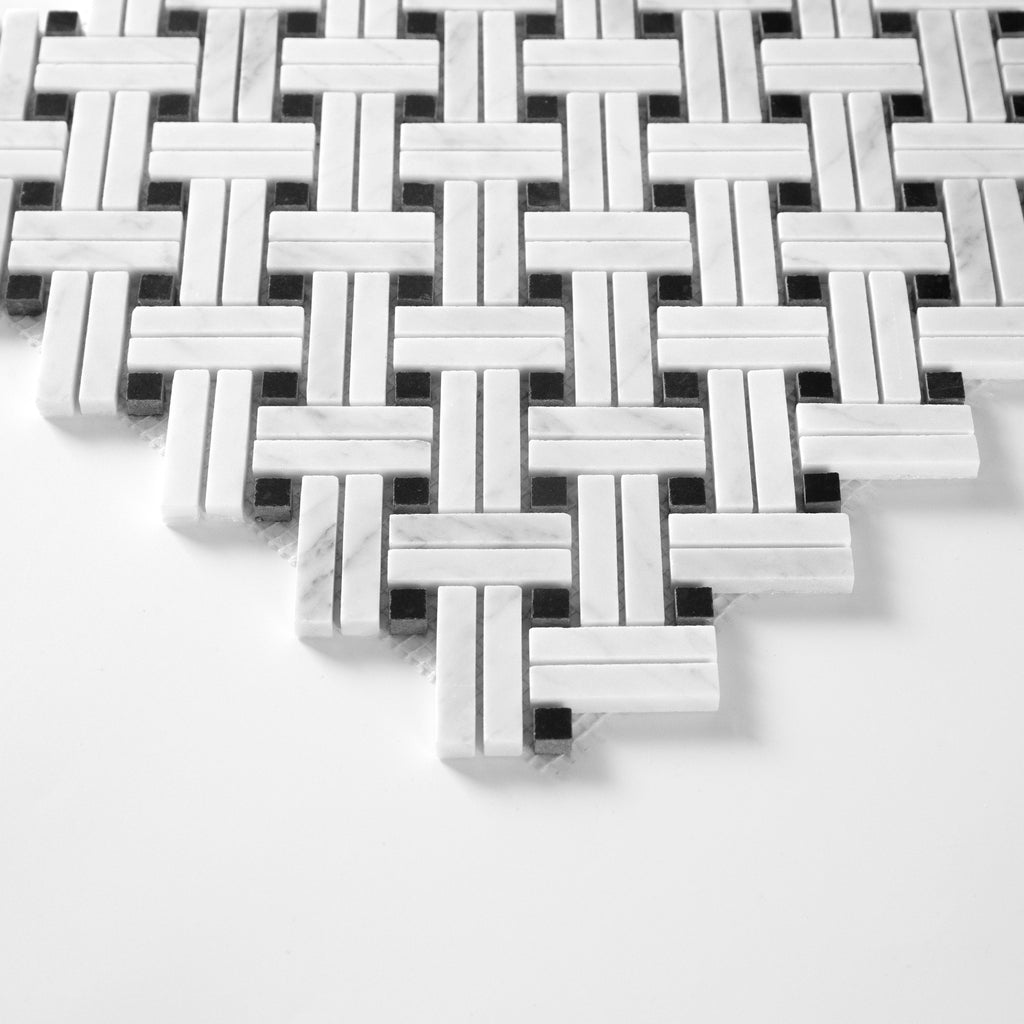Mosaic pattern of white and black tiles on a white background