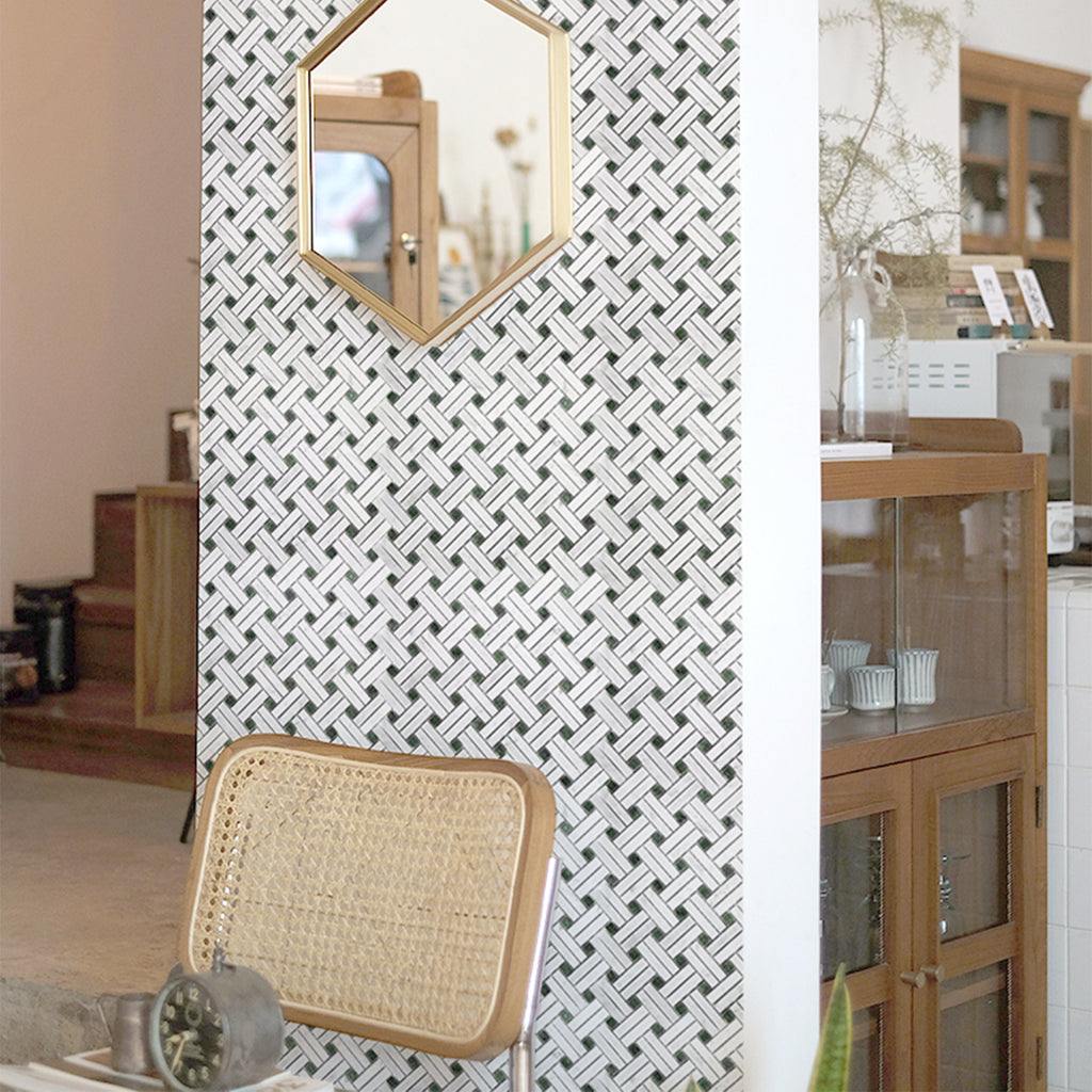 mosaic tile wall with geometric design, chair, and wooden cabinet in a room setting.