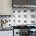 Modern kitchen with stainless steel stove and tiled backsplash
