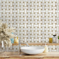 Bathroom with a geometric tile pattern, white sink, and decorative elements.