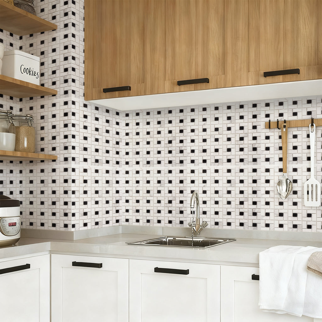 Modern kitchen with black and white tiled backsplash, wooden cabinets, and white countertops.