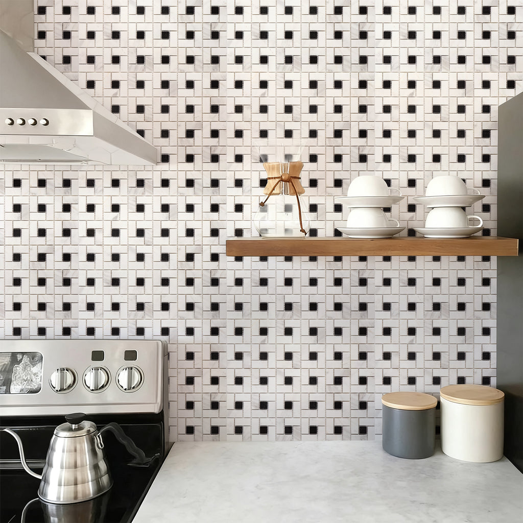 Kitchen with black and white tiled backsplash and wooden shelf.