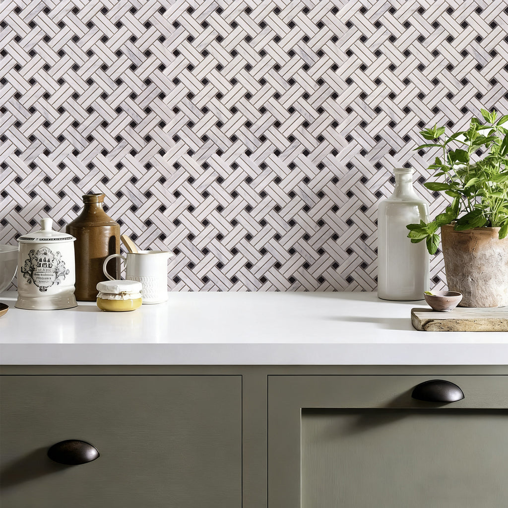 Kitchen counter with decorative vases and a plant against a geometric patterned wall.