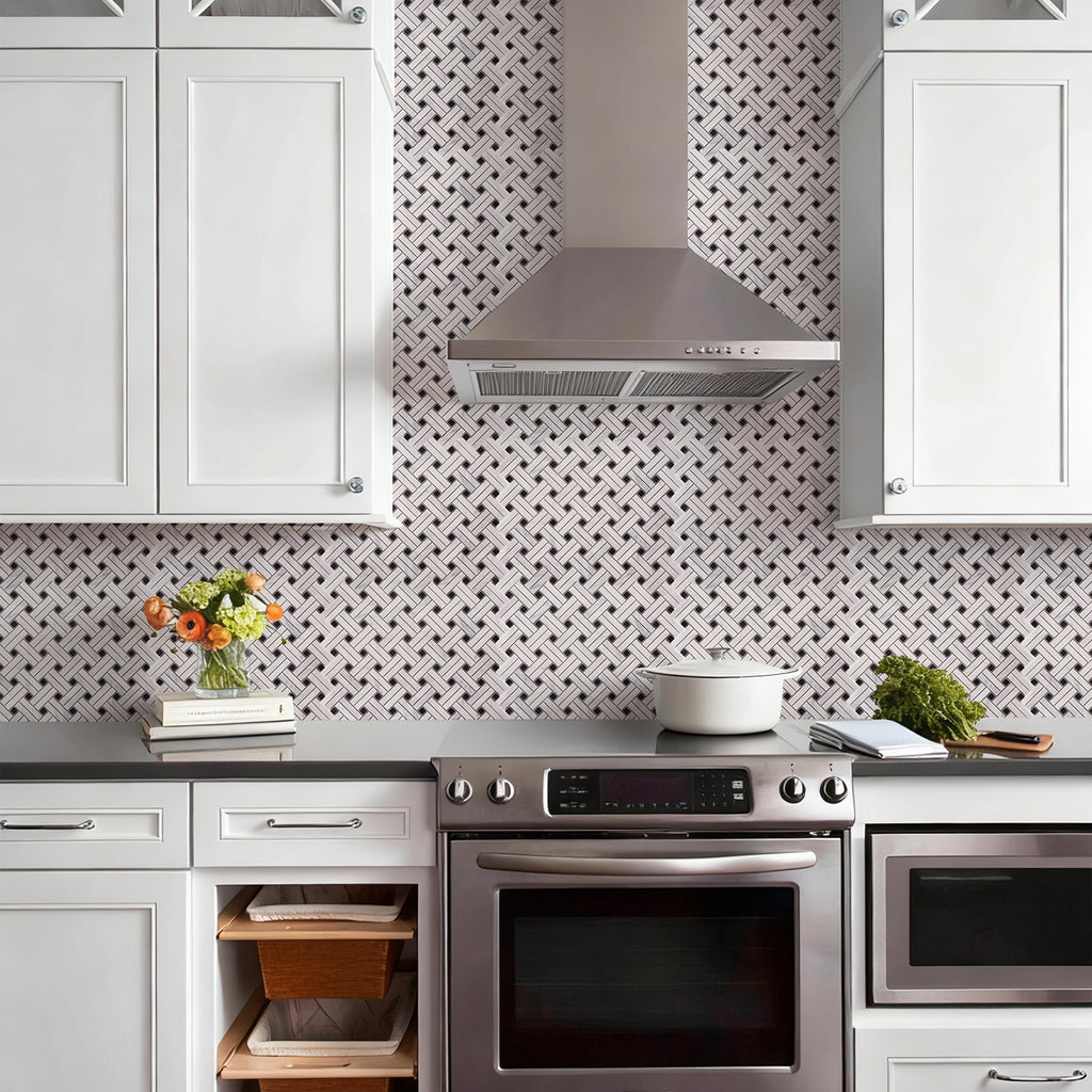 Modern kitchen with stainless steel appliances and geometric wall pattern