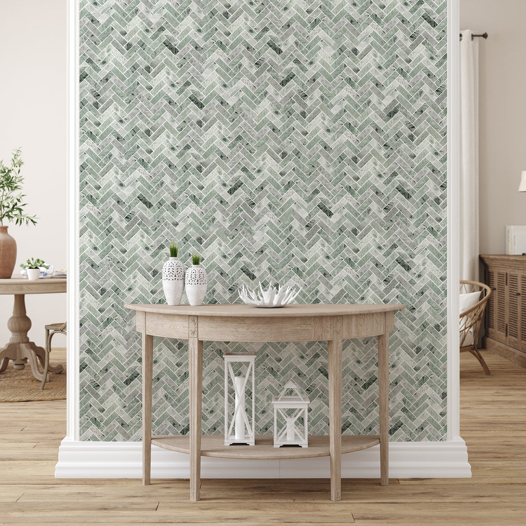 Room interior with a wooden console table against a wall with green herringbone patterned wallpaper.