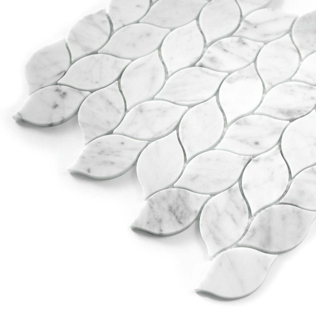 White carrara marble mosaic tiles with leaf-shaped patterns on a white background
