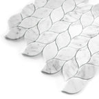 White carrara marble mosaic tiles with leaf-shaped patterns on a white background