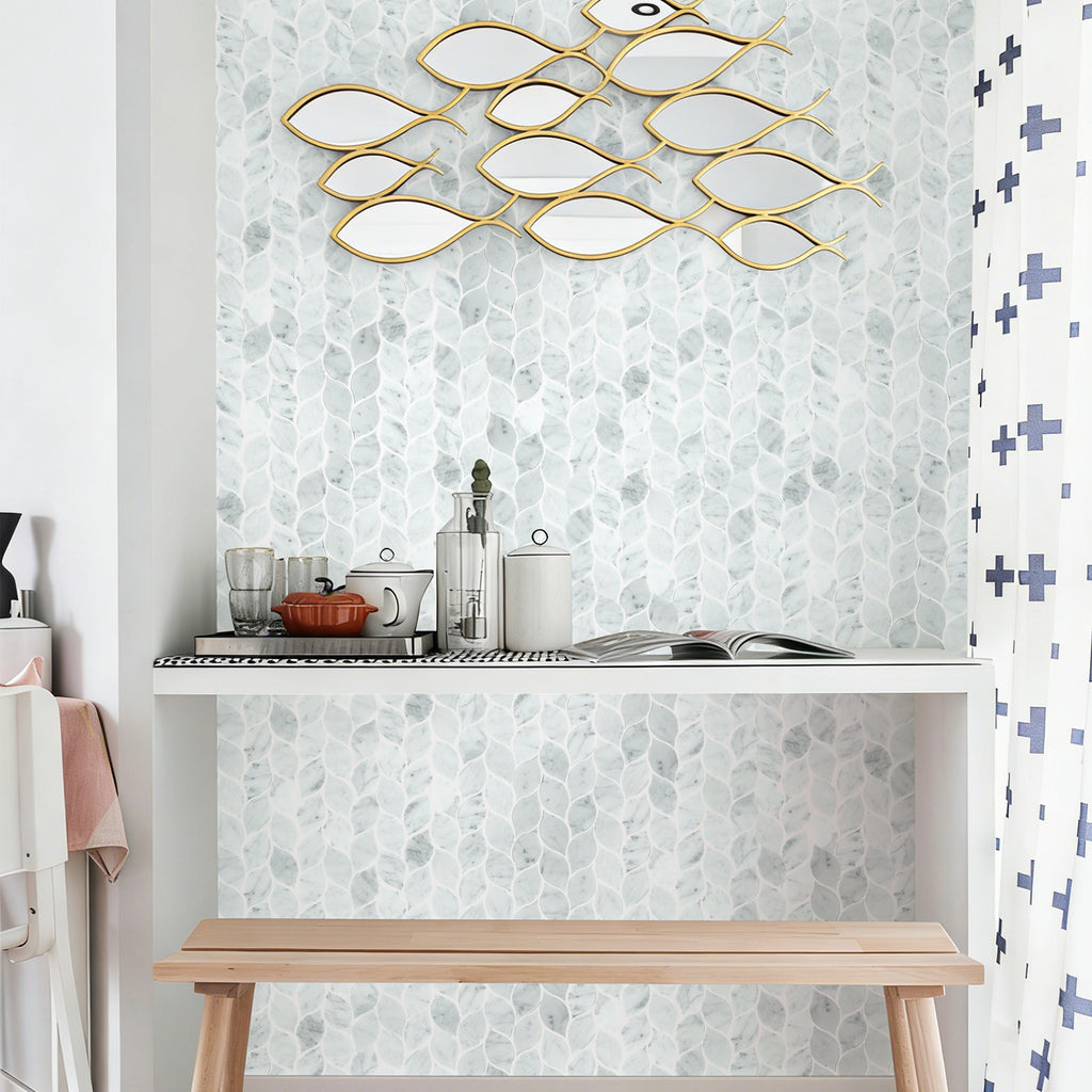 Decorative wall art with gold fish shapes on a light gray wall.
