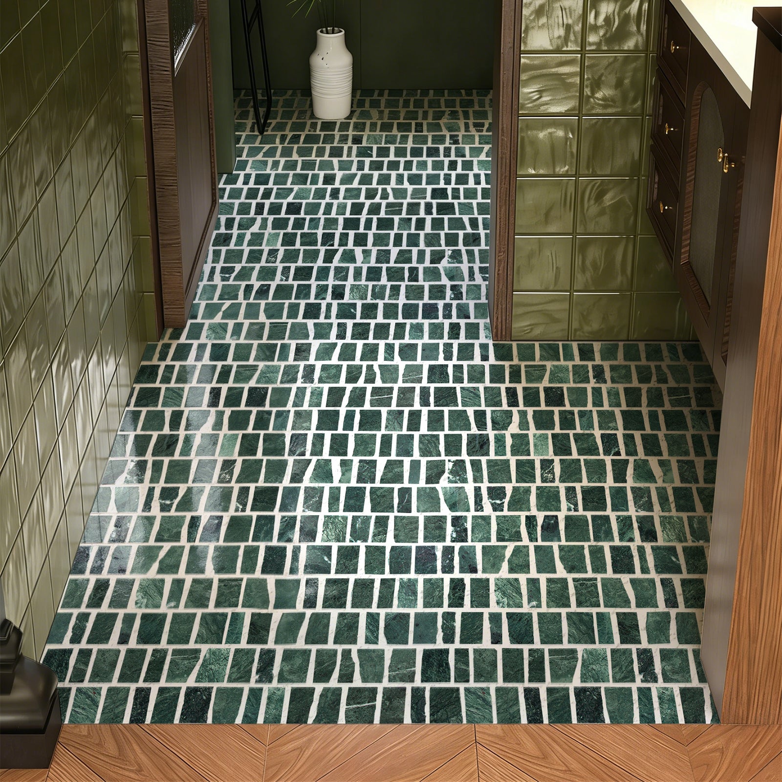 Green tiled bathroom floor with wooden door in a home interior.