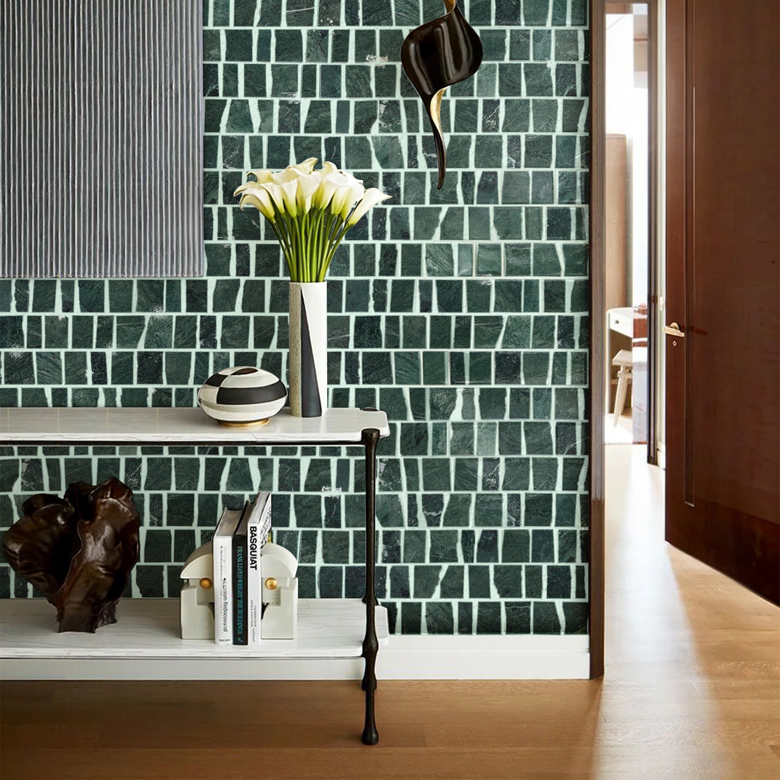 Green mosaic tile wall with decorative items on a shelf