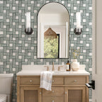 Bathroom with wooden vanity, mirror, and geometric wallpaper