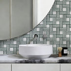 Bathroom vanity with a round white sink, marble countertop, and geometric patterned wall tiles.