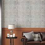 Living room with brown sofa, side table, and patterned wall.
