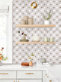 Kitchen interior with geometric patterned wallpaper, wooden shelves, and decorative items.