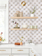 Kitchen interior with geometric patterned wallpaper, wooden shelves, and decorative items.