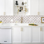 Modern kitchen with white cabinets, marble backsplash, and gold fixtures.