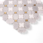 Hexagonal mosaic tiles with a mix of gray, white, and gold colors on a white background.