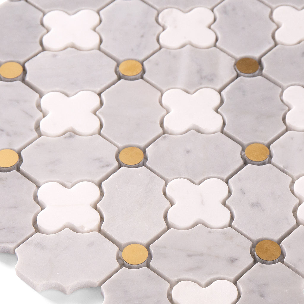 Close-up of hexagonal tiles with white and gold patterns