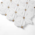 Close-up of a textured white mosaic surface with gold accents