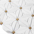 Close-up of a white mosaic tile with gold accents