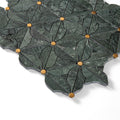Decorative stone tile with leaf pattern and gold accents on a white background