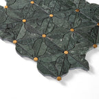 Decorative stone tile with leaf pattern and gold accents on a white background