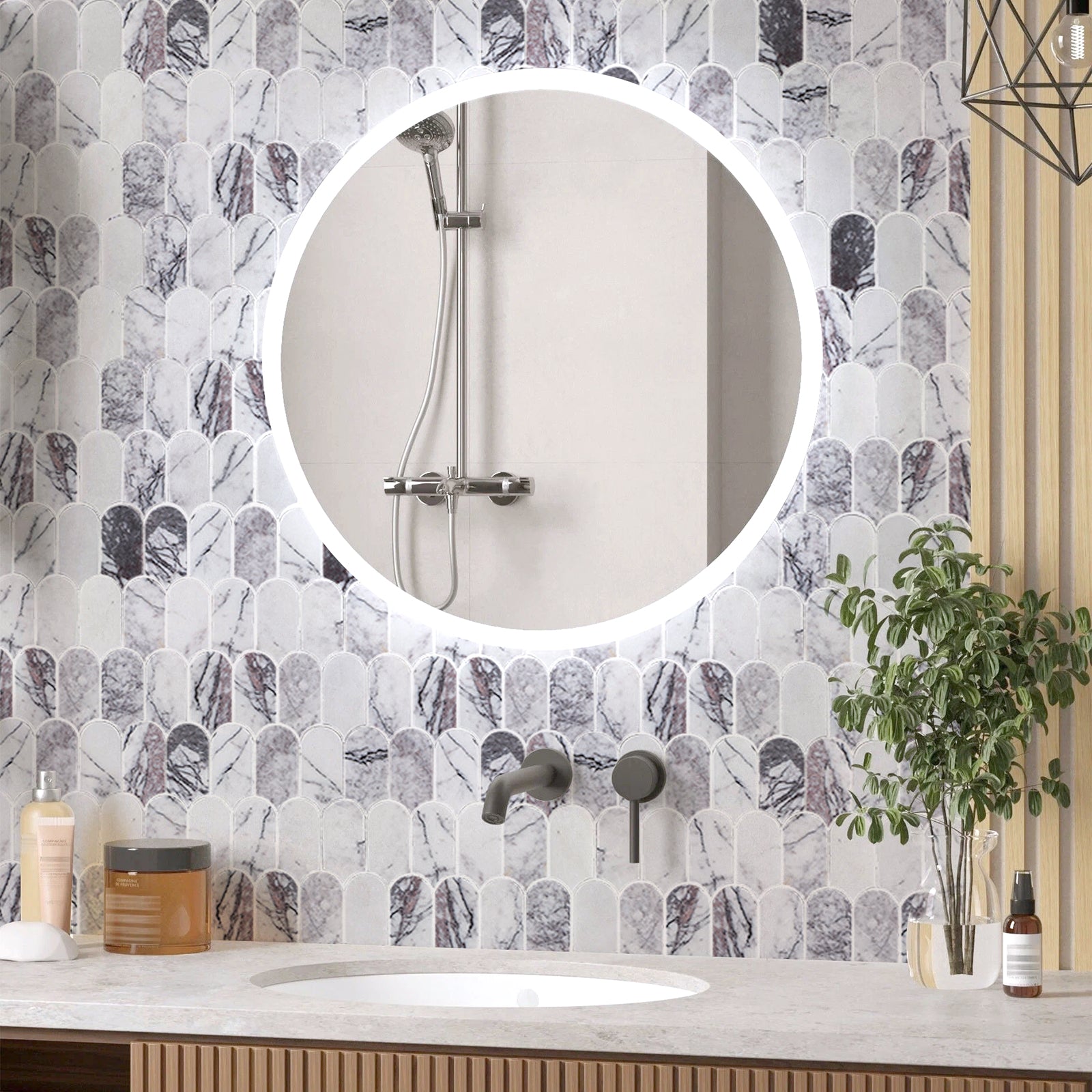 Bathroom with round mirror, tiled wall, and decorative elements.