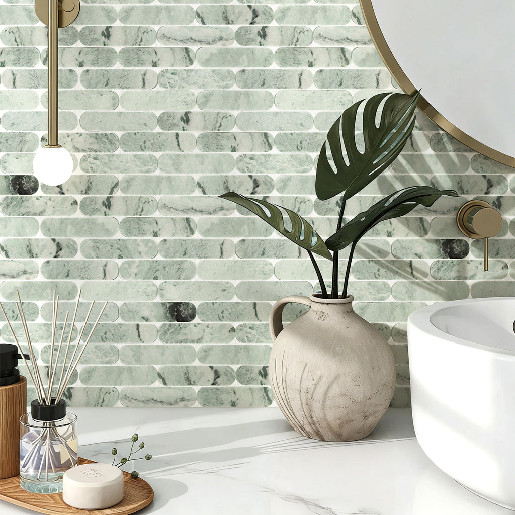 Bathroom interior with green marble tile wall, white sink, and decorative elements.