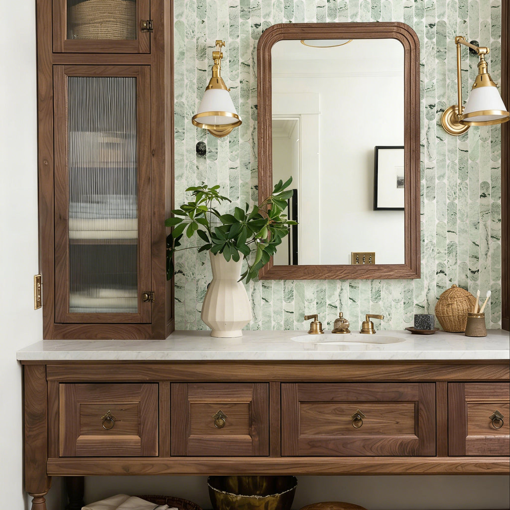Bathroom vanity with wooden cabinets, mirror, and decorative items.